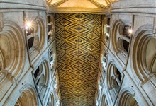 View from the great West doors of the font and great Norman arches of the nave supporting the 13th century painted wooden ceiling