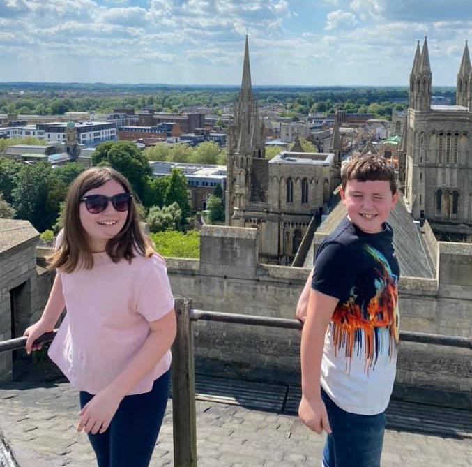 Two young people at the top of the Cathedral tower. Click to book a Tower Climb