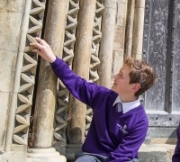 A student examining the carved stonework outside the Cathedral